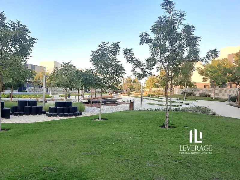 Central park with trees, seating and walking paths at Al Burouj