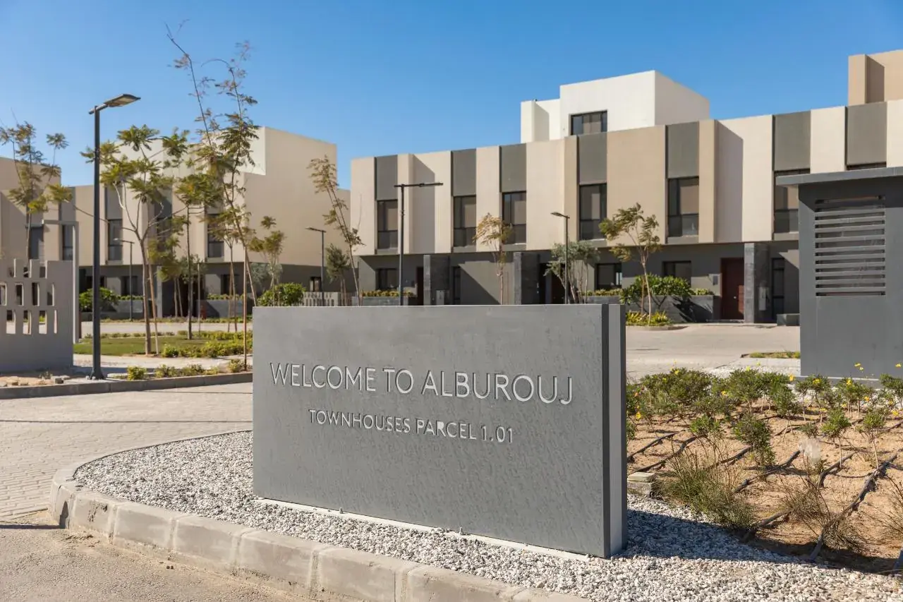 Welcome to Al Burouj sign in front of a row of townhouses
